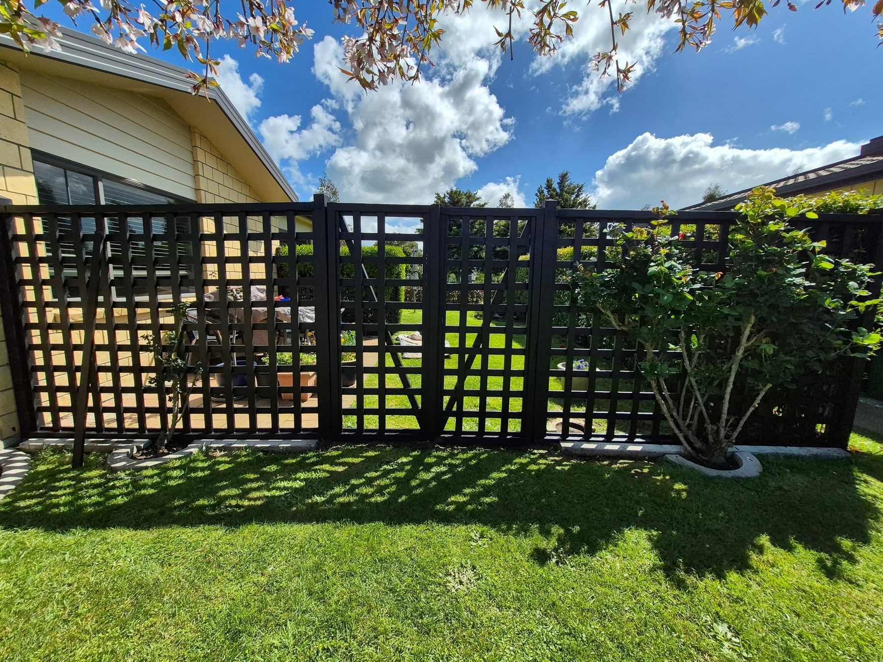 Black slat trellis fence